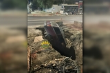 На проспекте Строителей легковушка провалилась в гигантскую яму на дороге